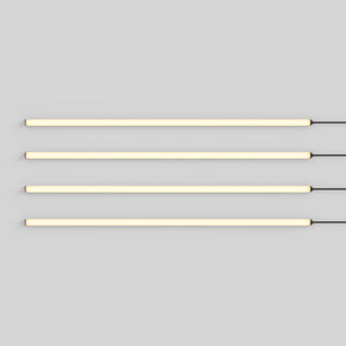 Four Lumilok LED Wall Panel Lights by Artika glow on a gray wall, cords right; includes remote for Sonolok.