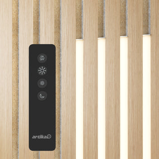 A black remote rests on Artika’s Lumilok LED Wall Panel Light for Sonolok, featuring vertical LEDs between wooden slats.