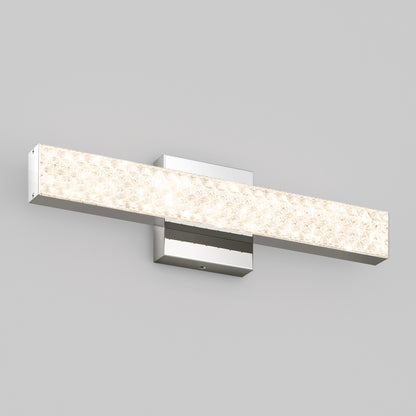 The Adeline modern LED bathroom vanity light 3 CCT by Artika features a textured, illuminated front panel and chrome base, shown mounted on a light gray wall.
