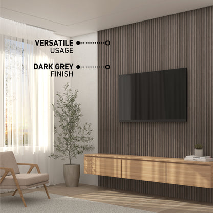 Modern living room with a wall-mounted TV on a dark grey slatted accent wall, floating wooden cabinet, armchair, potted plant, and large window with sheer curtains. Text reads: Versatile Usage and Dark Grey Finish.