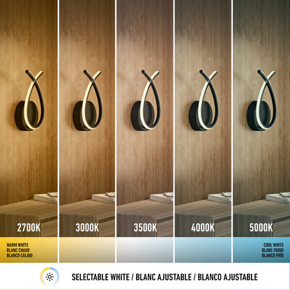 Artika’s Gamma modern LED wall sconce 5 CCT displays five white light temperatures (2700K–5000K) on a wood wall, from warm to cool. Text below explains selectable white in English, French, and Spanish.