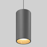 A modern cylindrical pendant light with a matte black exterior, suspended from a black cord. The inner surface is wooden, and the light is lit, casting a warm glow. The background is plain light gray.