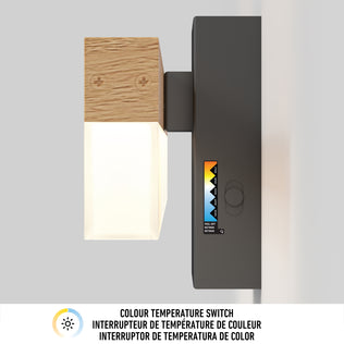 The Artika Neil modern LED bathroom vanity light is a wall-mounted fixture with wood and frosted accents, a side color temperature switch, and a color scale. Below, text describes the switch in three languages.