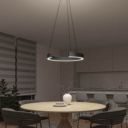 A modern kitchen and dining area with a round wooden table, four gray chairs, a white vase with twigs, and the Artika Vance modern LED pendant light 3 CCT hanging above. Sleek cabinets, a countertop, and a plant complete the background.