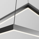 Close-up of a modern, black, rectangular pendant light fixture with integrated LED strips suspended from the ceiling by thin cables against a plain, light-colored background.
