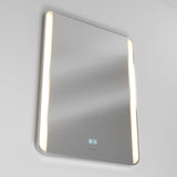 A rectangular, wall-mounted smart mirror with rounded edges, illuminated vertical LED light strips on both sides, and touch-sensitive control icons displayed on the lower front surface.
