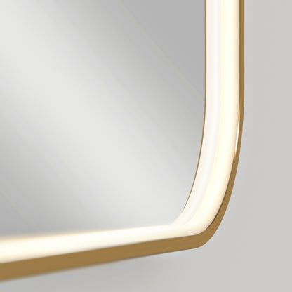 A close-up of the Artika Royce Dimmable LED Mirror, 3 CCT, shows its rectangular shape with rounded corners and a gold frame. Integrated adjustable lighting emits a soft glow, accentuating its smooth curves against a plain, light background.