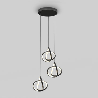 The Artika Zephyr 3-light LED pendant features three circular LED rings suspended by black cords from a round black ceiling mount, creating a modern look against a plain gray background.