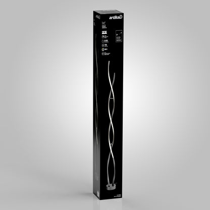 A tall, rectangular black box with the Artika logo features the Swirl modern LED floor lamp in silver and white on the front, set against a plain light gray background.