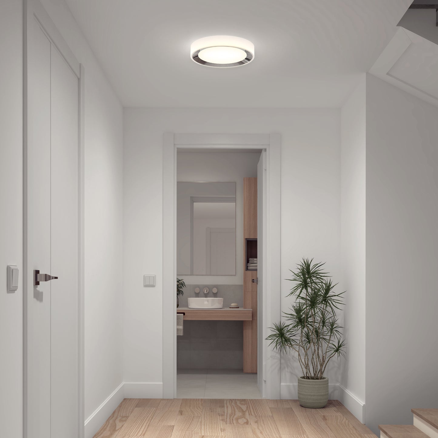 A bright, modern hallway with white walls, wooden floor, a potted plant, and a view into a bathroom with large mirror and sink is illuminated by the Artika Cooper LED flush mount light with remote.