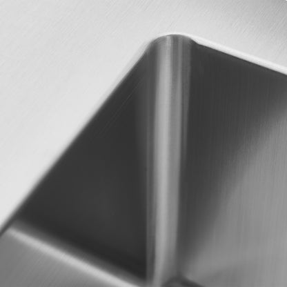 Close-up of the Artika Plaza Bar Single Bowl Sinks brushed metal surface, with sharp geometric edges and soft lighting highlighting its texture and contours.