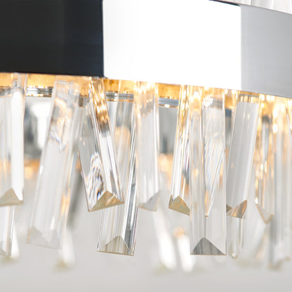 Close-up of the Artika Enchanted LED pendant light, featuring hanging crystal prisms that reflect warm light for a sparkling, elegant effect. The softly blurred background highlights its modern design.