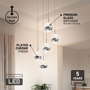 Five Artika Oracle modern 5-light LED pendants hang at various heights, with labels and warranty icons in a chic chandelier display.