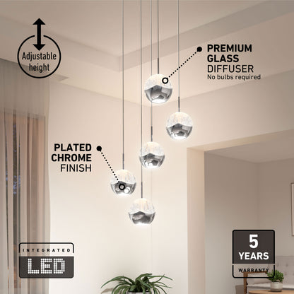 Five Artika Oracle modern 5-light LED pendants hang at various heights, with labels and warranty icons in a chic chandelier display.