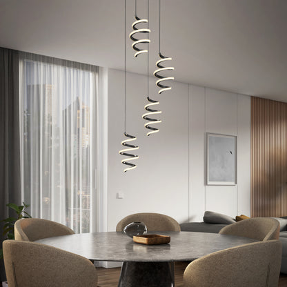 A modern dining room features a round table, four beige chairs, and the Artika Chorus 4 light LED pendant 5 CCT overhead. Large window with sheer curtains reveals a city view. Minimalist decor highlights light and dark accents.