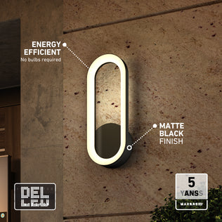 Oval, matte black Aiden modern LED indoor-outdoor wall light 5 CCT on a textured wall, featuring an energy-efficient, bulb-free design.
