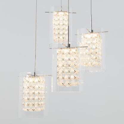 The Artika Crystal Cube 4-light LED pendant light features modern cylindrical glass shades with intricate illuminated crystal-like interiors, suspended at varying heights against a plain light gray background.