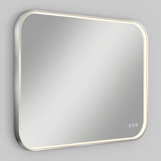 The Artika Royce Dimmable LED Mirror, 3 CCT, mounts horizontally or vertically and features rounded corners, built-in LED border lights, and three touch control buttons— including adjustable color temperature—set against a light gray wall.