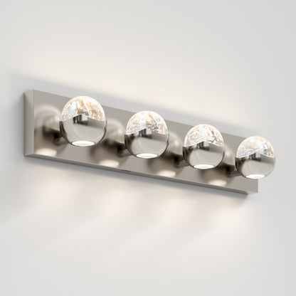 The Artika Oracle 4 light LED bathroom vanity light features four spherical glass and metal lights on a sleek rectangular base, mounted on a white wall, providing modern soft white illumination.