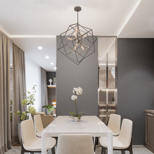 Modern dining room with a white table, six beige chairs, and an Artika Imperium 9-light chandelier above a potted orchid centerpiece.