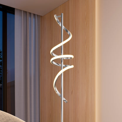 The Artika Coda modern LED floor lamp 5CCT with a twisted spiral design stands beside a wooden wall and curtained window, casting a warm glow in a contemporary space.