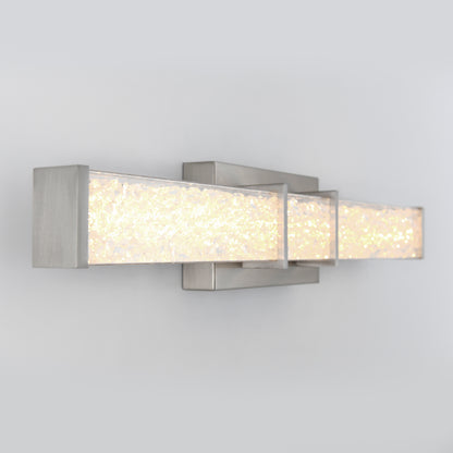 The Artika Royale LED bathroom vanity light features a modern rectangular design, textured illuminated glass, and a brushed metal frame, shown wall-mounted against a plain light gray background.