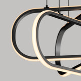 Close-up of two modern, oval-shaped pendant lights with black frames and integrated LED strips glowing warmly, suspended against a neutral gray background. The design is sleek and minimalistic.