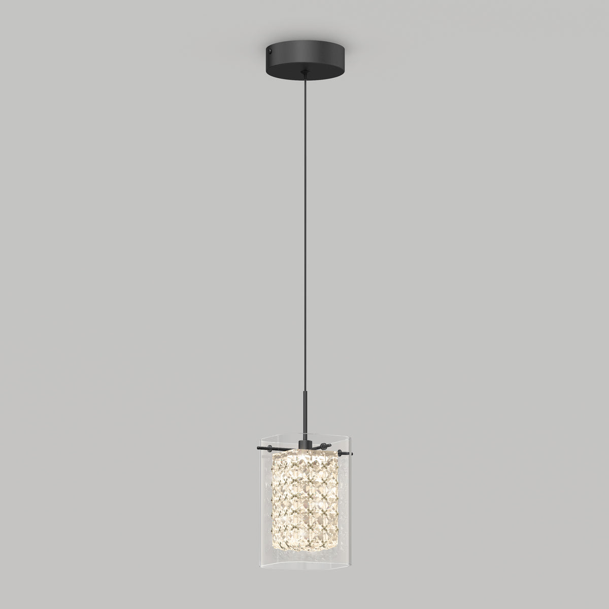A modern pendant light with a black ceiling mount, a thin black cord, and a cylindrical crystal glass shade emitting a soft, bright glow against a plain light gray background.