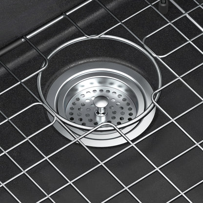 Close-up of Artika Baycrest 33 in. Black Single Bowl Sink with metal strainer and grid cover inside the basin.