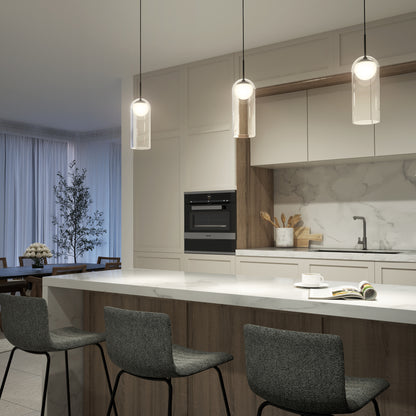 Modern kitchen featuring a marble island, three gray barstools, built-in oven, white cabinetry, sink, and the Artika Mirah LED modern mid-century pendant light (3 CCT). Dining area and large curtained window are also visible.