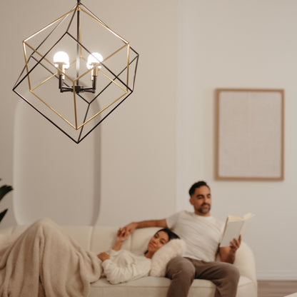 An Artika Peyton LED modern mid-century pendant light hangs in the foreground, while a couple relaxes on a cream-colored sofa in the background; one reads a book, the other lounges under a blanket.