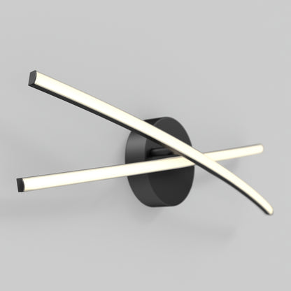 The Orly modern LED bathroom vanity light by Artika features two curved, illuminated bars crossing on a round black base, adding a stylish touch to any gray wall.