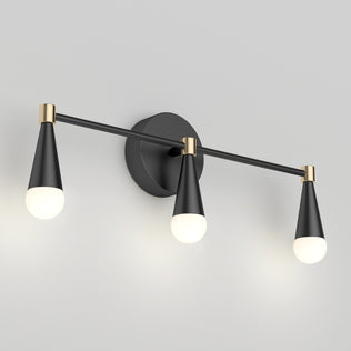 The Artika Wayden LED mid-century vanity light features 3 cone fixtures in black and gold, shown on a grey wall.