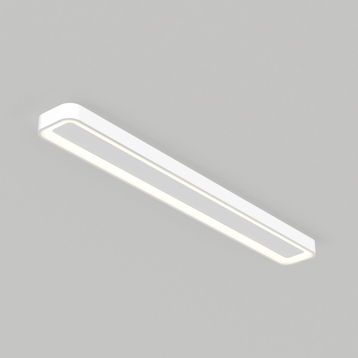 A modern, rectangular, white ceiling light fixture with rounded edges, installed on a plain light gray ceiling. The light is on, emitting a soft, even glow.