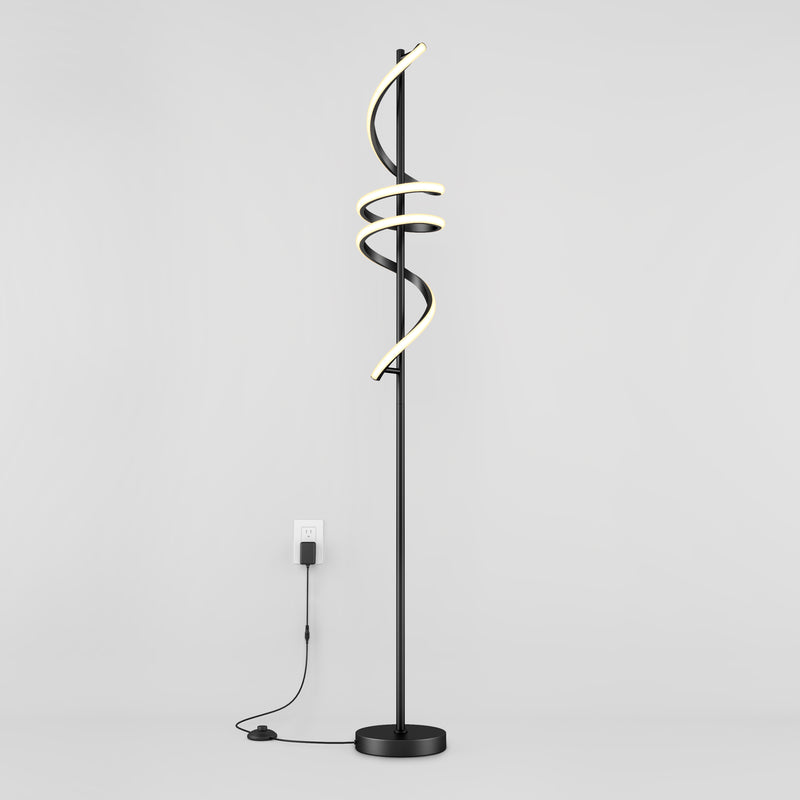 The Artika Coda modern LED floor lamp 5CCT features a black stand with three spiral LED light tubes, dimmable for customizable ambiance, standing against a white wall and plugged into a wall outlet.