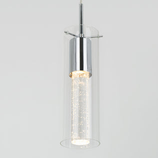 The Artika Bubble Flow 1-light pendant 2 features a modern cylindrical glass shade with chrome accents and an inner frosted tube filled with bubbles, all suspended against a plain light gray background.