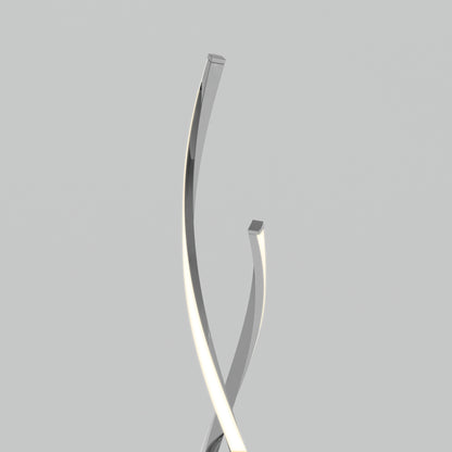 The Artika Swirl modern LED floor lamp features two sleek, metallic, curved rods that intersect and twist upward against a plain light gray background, with one rod emitting a soft white light along its edge.