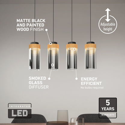 The Artika Hanson 4-light LED pendant features matte black and painted wood finishes with smoked glass diffusers above a table. This fixture offers adjustable height, energy efficiency, integrated LEDs, 5 CCT options, and a 5-year warranty.