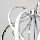 A modern light fixture with intertwined, curved metallic and illuminated strips, creating an abstract, sculptural design against a plain light background.