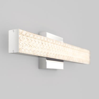 The Adeline modern LED bathroom vanity light 3 CCT by Artika features a rectangular textured glass cover and sleek metal base, casting a warm glow on your wall.