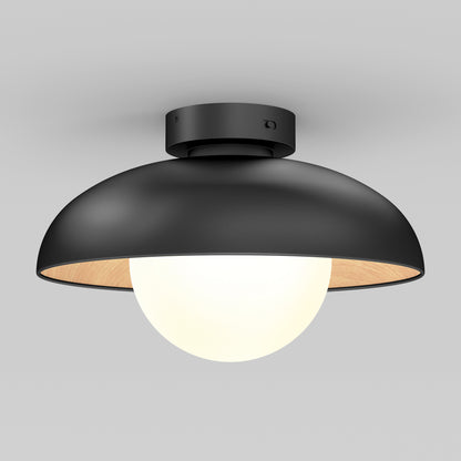 The Artika Boden LED flush mount light features a matte black dome-shaped shade and a white globe bulb, mounted on a gray ceiling.