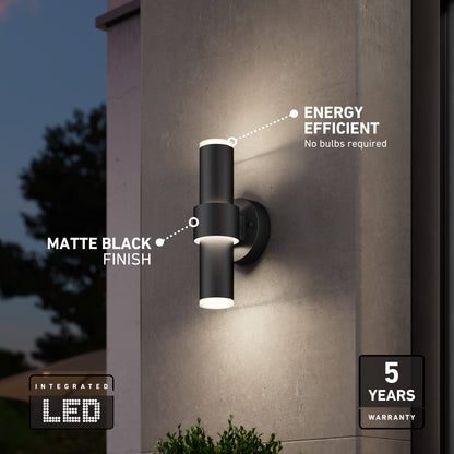 The Artika Dani modern LED indoor-outdoor wall light 5 CCT features a sleek cylindrical design, matte black finish, energy efficiency, integrated LED, and comes with a 5-year warranty—ideal for stylish illumination at dusk.