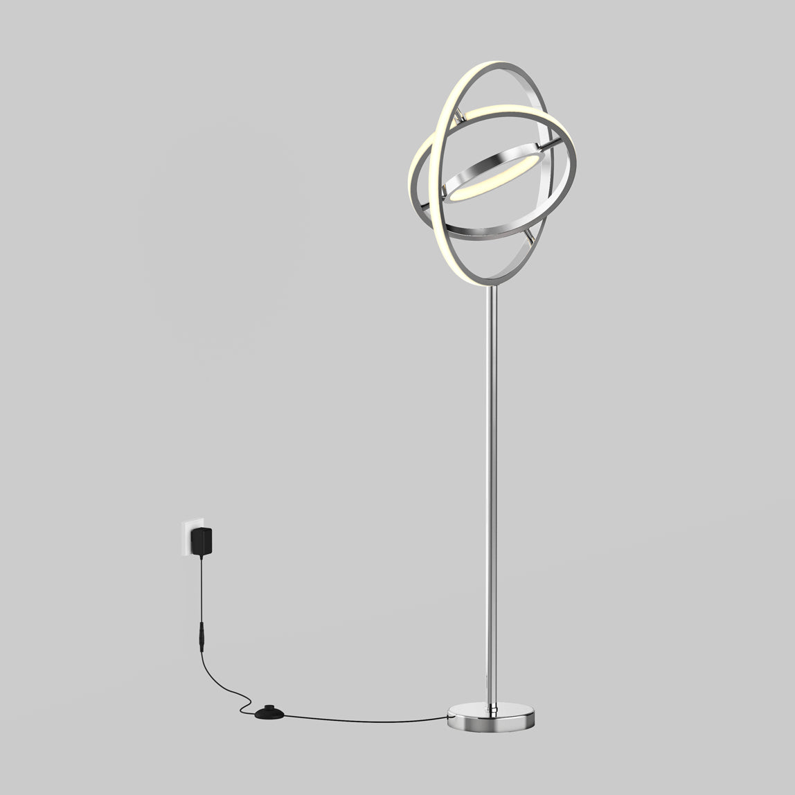 The Artika Pivot modern LED floor lamp 3 CCT features interlocking circular LED rings, a chrome base, and a black power cord for wall outlet connection, set against a plain gray background.