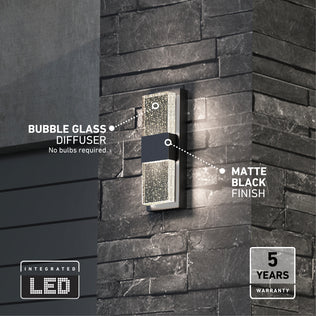 The Artika Mazza Bubble indoor-outdoor LED wall light, featuring a bubble glass diffuser and matte black finish, is shown mounted on a dark brick wall with highlighted features and a 5 years warranty badge in the corner.