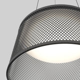 Close-up of a modern pendant light with a black metal mesh shade and a glowing white inner diffuser, suspended by two thin wires against a plain gray background.