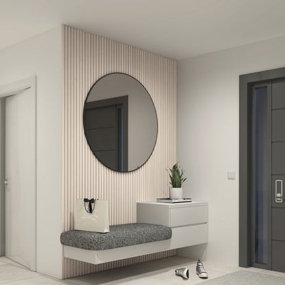 A modern entryway features Artika’s Panolok 30.67 ft wall panel kit, a floating gray bench, round mirror, small white drawer with potted plant, shopping bag, and sneakers next to a dark door.