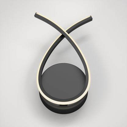 The Artika Gamma modern LED wall sconce 5 CCT features two curved black arms crossing at the top with integrated LED strips, all on a round black base, creating a minimalist modern look.