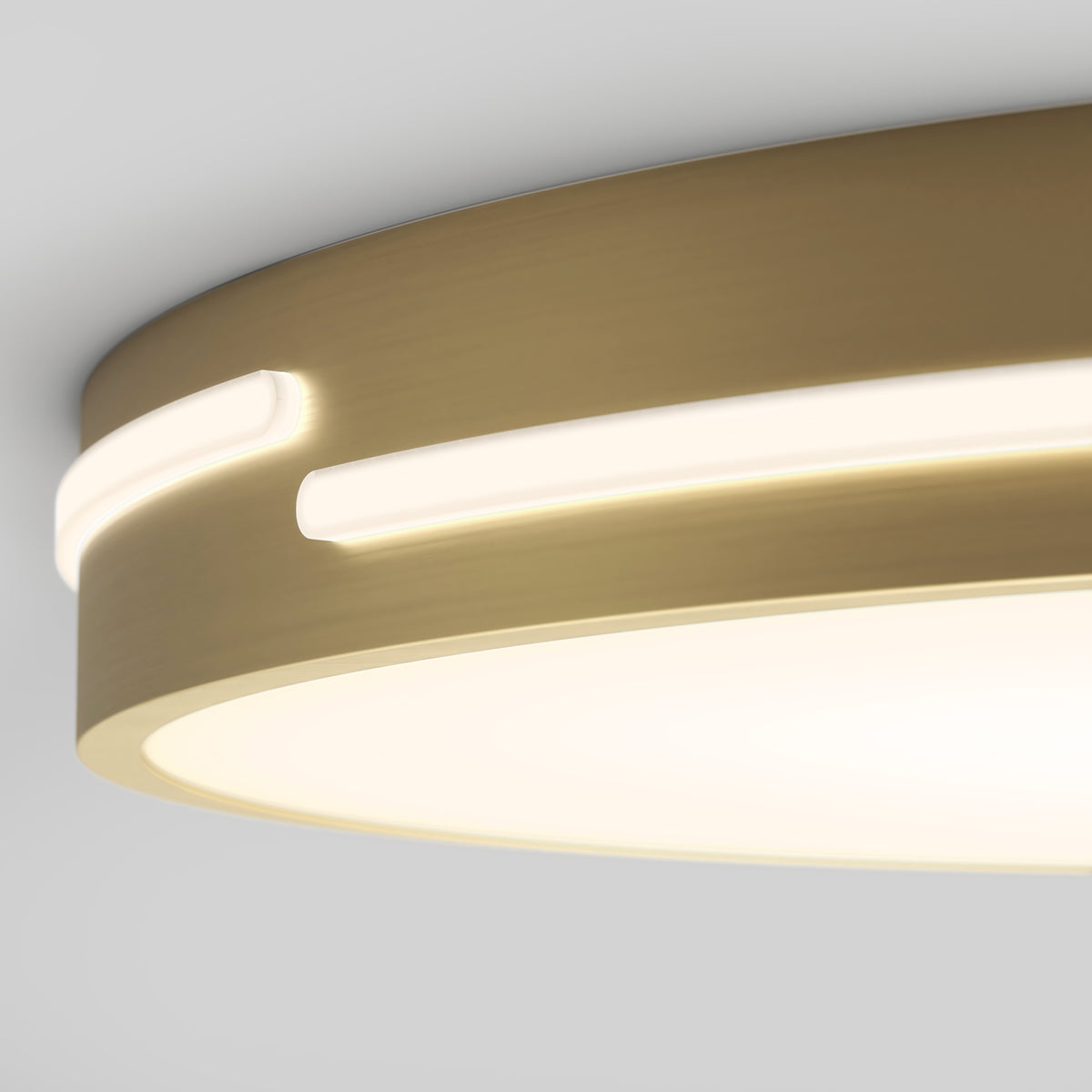 A close-up view of a modern, circular ceiling light with a beige or gold metallic finish and glowing LED strips embedded around its edge.