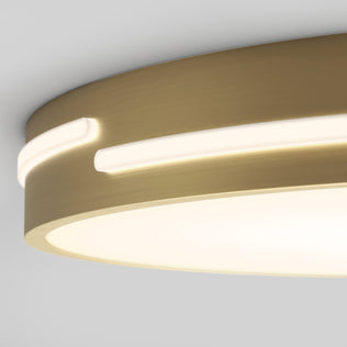 Close-up of the Artika Delray 15.7 in. LED modern flush mount light, featuring a circular design with brushed gold finish and built-in 5 CCT LED strips, emitting a soft warm glow and mounted on a white ceiling.
