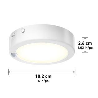 The Artika Accent under cabinet LED light 3CCT is a round, white puck light with a 10.2 cm (4 in) diameter, 2.6 cm (1.02 in) height, and features a visible motion sensor on the side.